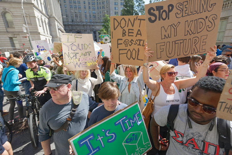 On Chambers Street, Todd Dimmick and son Rome march along Chambers Street, with Lucinda Depew, Lila Kerns and Christine Dimmick behind. Photo: Carl Glassman/Tribeca Trib
